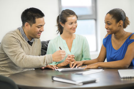 a pair of individuals signing documents with a notary public present.